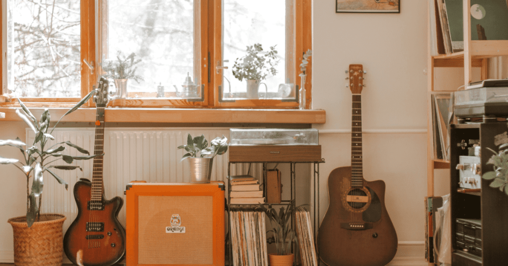 room with guitars and books