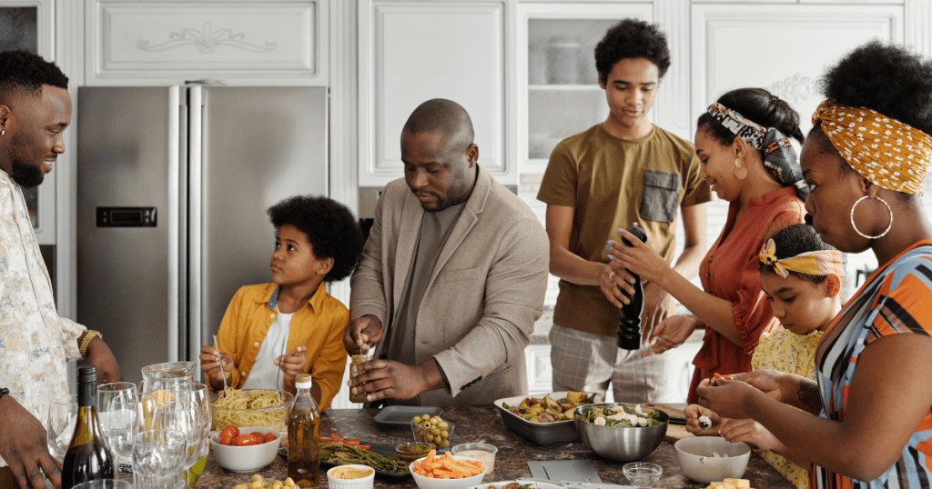 family around the kitchen island with food for holidays