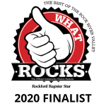 Logo for "What Rocks" with a circular design featuring a thumbs-up in the center. Text reads "The Best of the Rock River Valley" and "Rockford Register Star" at the bottom. Colors include red, black, and white.