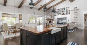 Lake Geneva WI kitchen design idea with farmhouse sink, wood ceiling beams, and open floor plan blending kitchen, dining, and living areas.